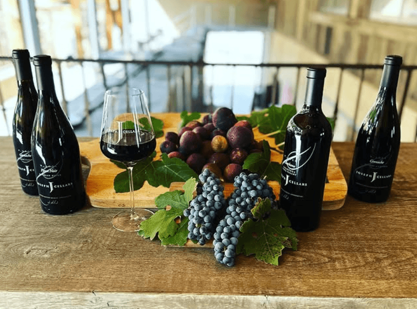 Wine bottles and glass at Joseph Cellars